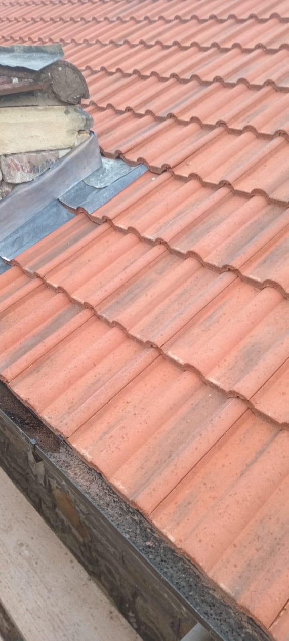 Fresh code-4 lead flashing dressed neatly around a chimney stack.
