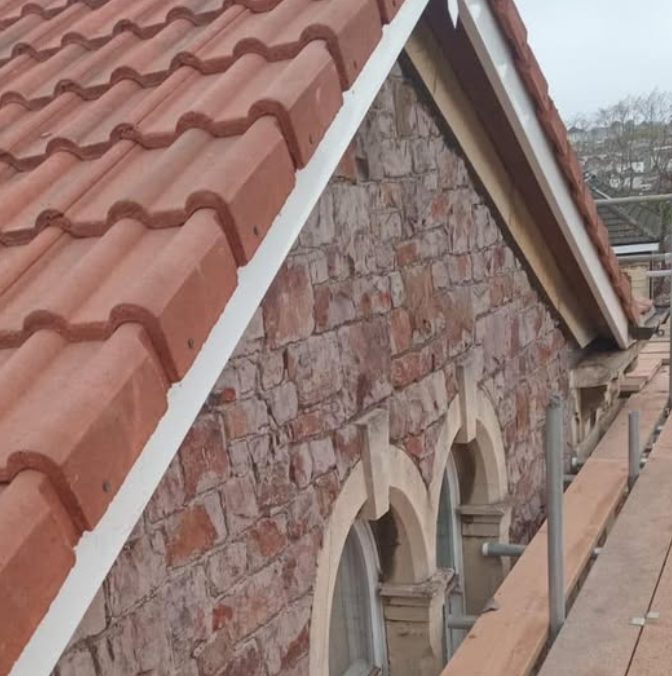 New clay tiles replaced on a period building — a lovely transformation.